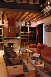 a living room filled with furniture and a fireplace at The Library Hotel Wellness Retreat in Kalavasos