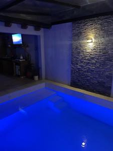 a swimming pool with blue lights in a room at Cassara Retreat in La Consulta