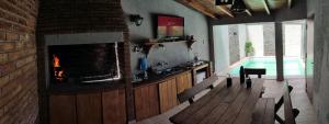 a living room with a fireplace and a swimming pool at Cassara Retreat in La Consulta