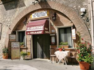 a restaurant with a table in front of a building at LucyBen GuestHouse in Cascia