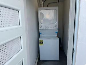 a television sitting on top of a refrigerator in a room at Shalex House 2 in Carolina