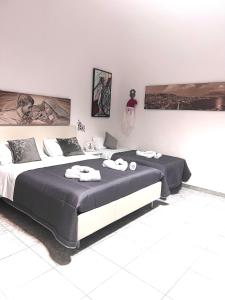 a bedroom with a large bed with towels on it at A Ninnella Casa Vacanze in Naples