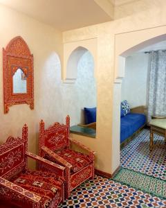 a room with two chairs and a bed and a mirror at Charming Oasis in Marrakesh in Marrakech +25 photos