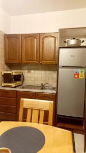 a kitchen with wooden cabinets and a white refrigerator at Charming Oasis in Marrakesh in Marrakech