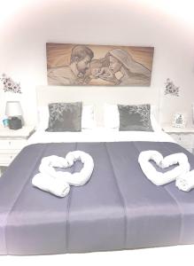 a bedroom with a bed with two towels on it at A Ninnella Casa Vacanze in Naples