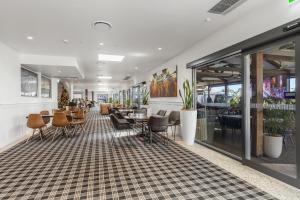 a lobby of a restaurant with chairs and tables at Peppers Hunter Valley - formerly Grand Mercure in Pokolbin