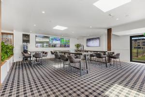 a lobby with a bar with chairs and tables at Peppers Hunter Valley - formerly Grand Mercure in Pokolbin