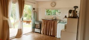 a kitchen with a sink and a stove top oven at Casa de Dani, acogedora casa decorada con estilo moderno y funcional 400 mts del mar in Playa Hermosa