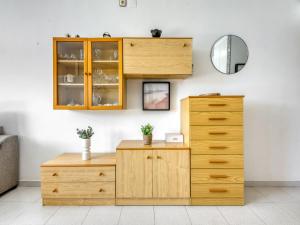 a wooden cabinet and a dresser in a room at Apartment in Roses near beach in Montjoys