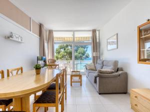 a living room with a table and a couch at Apartment in Roses near beach in Montjoys