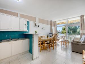 a kitchen and living room with a table and chairs at Apartment in Roses near beach in Montjoys +32 photos