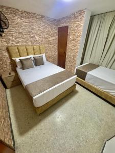 Voodi või voodid majutusasutuse Hotel Pereira Central toas