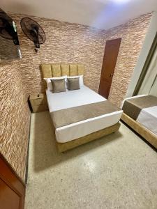 Voodi või voodid majutusasutuse Hotel Pereira Central toas