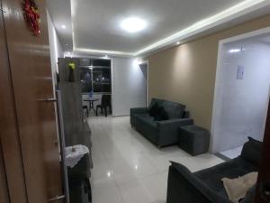 a living room with two couches and a table at Apartamento em Campo Grande RJ in Rio de Janeiro