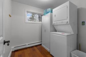 een witte keuken met een deur en een raam bij Forest House 1 Bdrm Qv Lake View Parking in St. John's