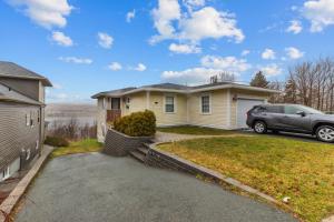 een auto geparkeerd voor een huis bij Forest House 1 Bdrm Qv Lake View Parking in St. John's