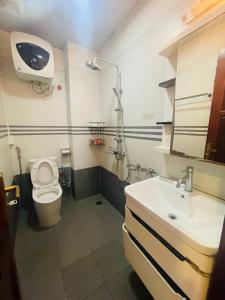 a small bathroom with a toilet and a sink at Laca Home in Hanoi