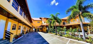 a building with palm trees next to a driveway at Phi-Phi Beach Resorts & Hotel in Malawin