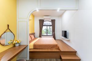 a small bedroom with a bed and a window at Yo'House Hue Homestay in Hue