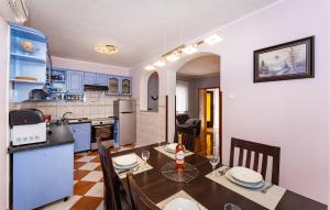 a kitchen and dining room with a table and chairs at Cdi941 in Slivnica