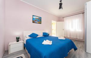 a white bedroom with a blue bed with blue sheets at Cdi941 in Slivnica