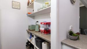 a kitchen with a counter with a mixer and aounter at Family Holiday Perfection in Bellara +16 photos