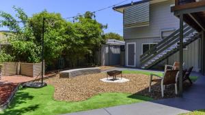 a backyard with a bench and a table at Family Holiday Perfection in Bellara