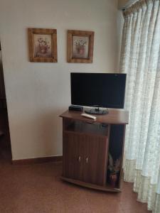 a flat screen tv sitting on a table in a room at Amanecer mensajero in San Bernardo +11 photos