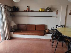 a brown couch in a living room with a table at Amanecer mensajero in San Bernardo