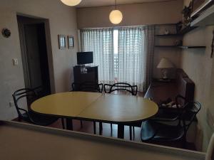 a table and chairs in a living room with a table at Amanecer mensajero in San Bernardo