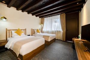 Postel nebo postele na pokoji v ubytování Kunming Mountain Wowo Hefeng Dieyuan B&B