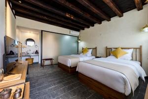 Postel nebo postele na pokoji v ubytování Kunming Mountain Wowo Hefeng Dieyuan B&B