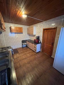an empty kitchen with a counter and a refrigerator at Casa Roxana in Predeal