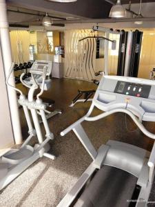 a gym with several treadmills and cardio machines at Studio deluxe cozy staycation Antel Spa Residences in Manila