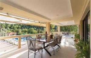 a dining room with a table and chairs on a balcony at Villa Pax Maris in Duba