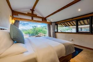Postel nebo postele na pokoji v ubytování Kunming Mountain Wowo Hefeng Dieyuan B&B