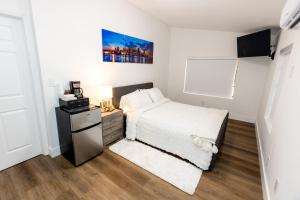 a small bedroom with a bed and a night stand at Best Room in Miami ! in Miami