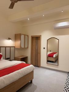 a bedroom with a bed and a mirror at Radhe Krishna Residency Nearest Triveni Sangam in Prayagraj