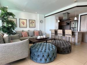 a living room with a couch and a table at Marbella-SeaView-FrontBeach-Cozy-2Br-2Bds-4Pax-WiFi in Villas del Mar