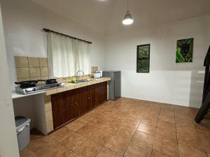 an empty kitchen with a sink and a stove at Aracari Eco Lodge in Corazón de Jesús