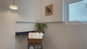 a room with a chair and a table with towels at 131 inn in Tainan +26 photos