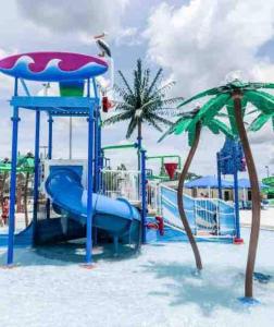 a playground with a slide and two palm trees at Newly updated house on huge lot in North Port