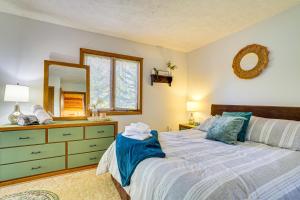 a bedroom with a bed and a dresser and a mirror at Walk to Beach Arrowhead Lake Home in Pocono Lake +28 photos