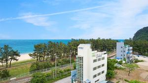 a view of a building and the beach at Gangneng badapunggeong Pension in Gangneung