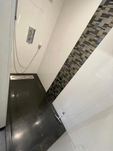 a metal elevator in a room with a brick wall at Neptune in Cavalaire-sur-Mer