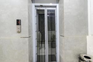 a glass shower in the corner of a bathroom at FabHotel SSR Ikon Suites - Nr Hyderabad Central University, Kondapur in Hyderabad