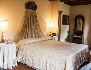 Ένα ή περισσότερα κρεβάτια σε δωμάτιο στο Locanda La Corte Dei Galli