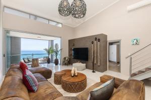 a living room with a couch and a table at The Crystal Apartments in Cape Town +39 photos