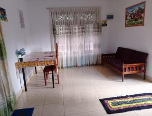 a living room with a table and a couch at Francy Villa Tangalle in Tangalle