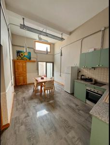 a kitchen with green cabinets and a table in it at Sunflower 2bedroom Flat North Nicosia-Turkish Side in Nicosia